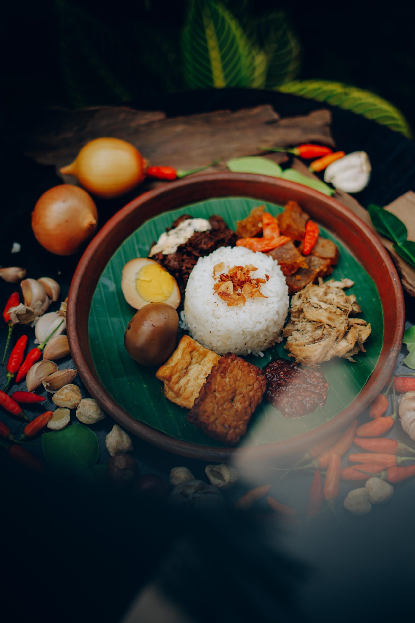 Indonesian nasi campur served with rice, egg, tempeh, and sambal.